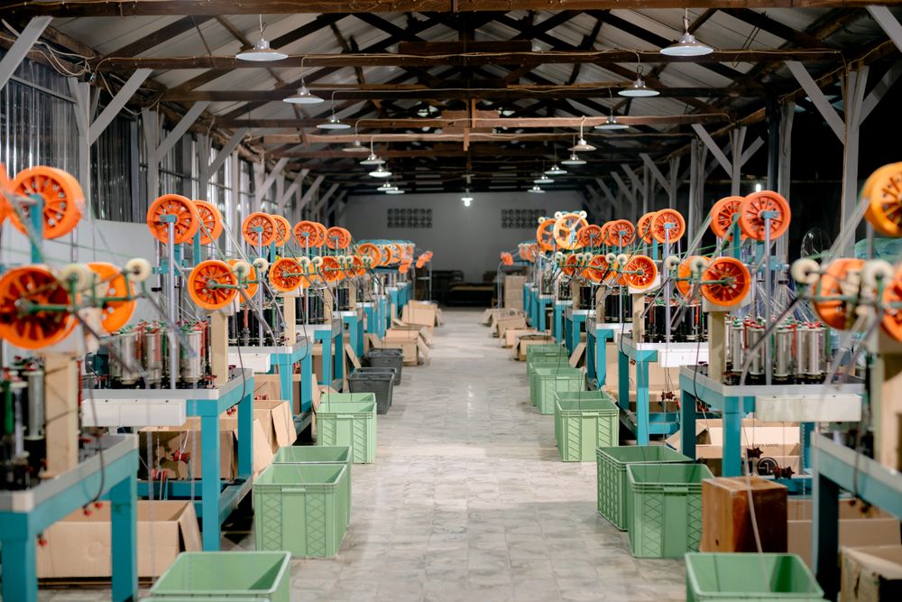 Rows of machines running in a manufacturing hall.